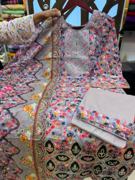 Elegant Pakistani-inspired Swiss Lawn suit with intricate boring work.